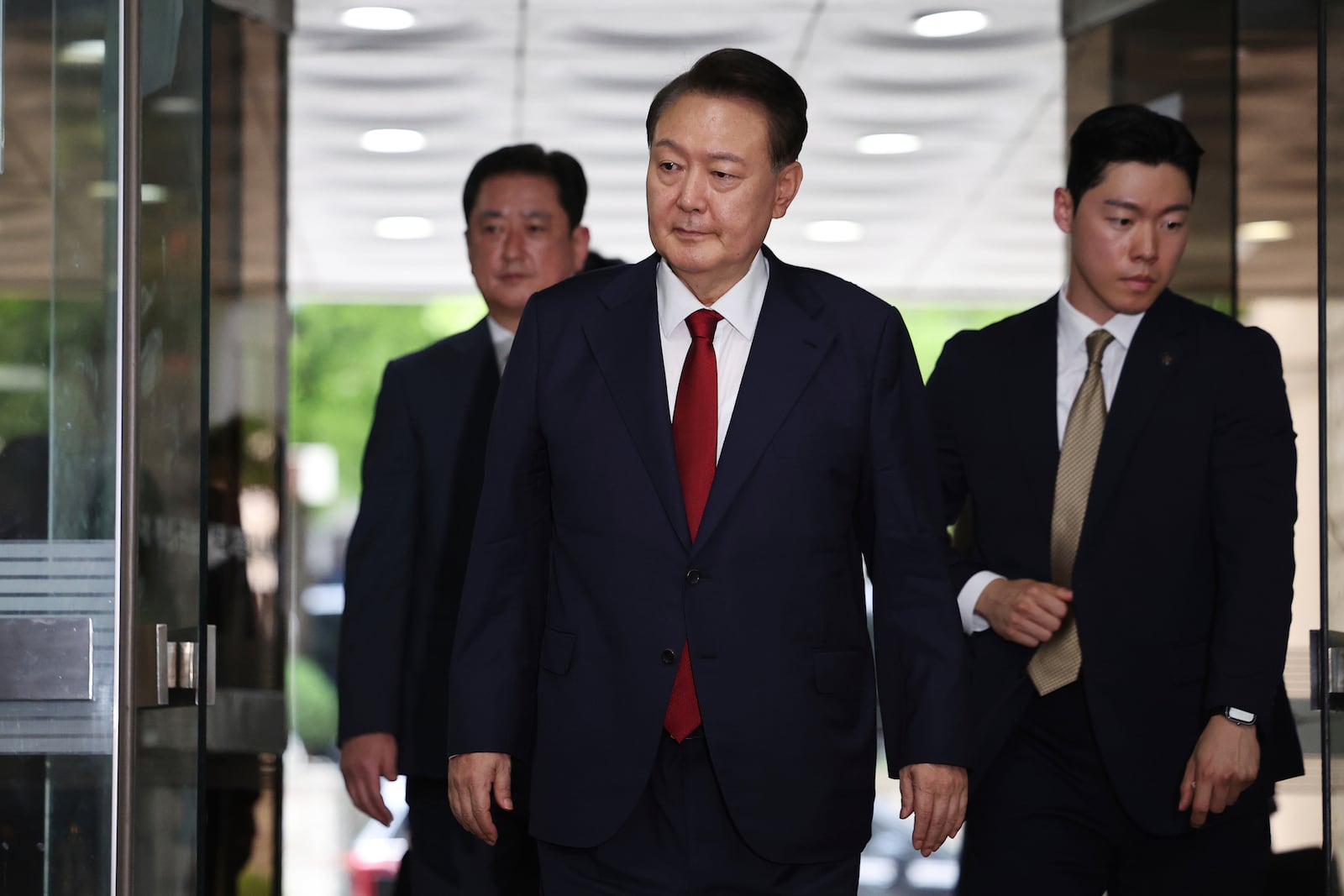 Former South Korean President Yoon Suk Yeol, centerm arrives at a court to attend a hearing to review his arrest warrant requested by special prosecutors in Seoul, South Korea Wednesday, July 9, 2025. (Kim Hong-Ji/Pool Photo via AP)