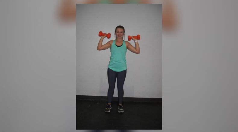 Position dumbbells at shoulder level.