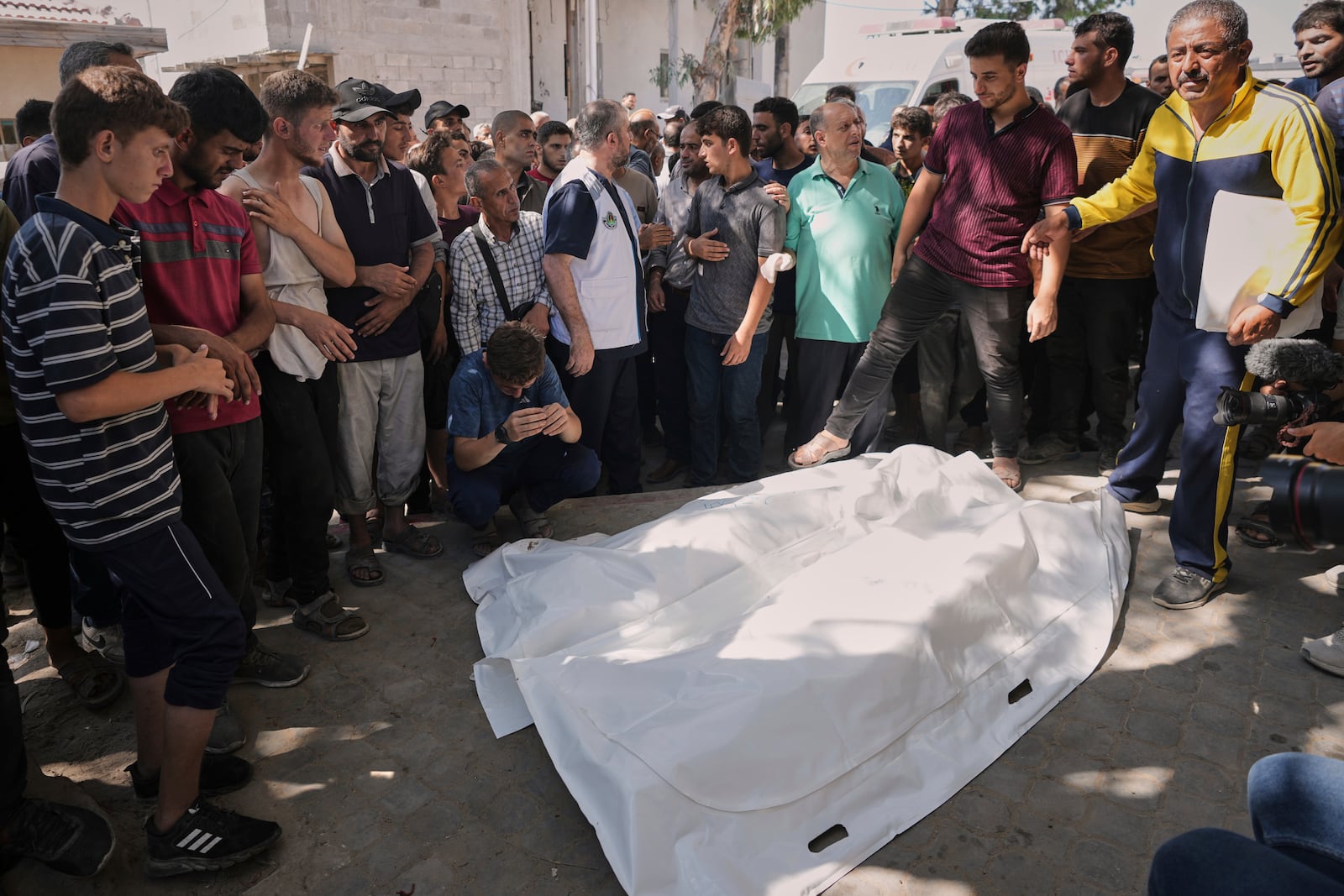 Palestinians gather around the bodies of Dr. Marwan Sultan the director of the Indonesian Hospital in the northern Gaza Strip, his wife, daughter, and son in law, after they were killed in an Israeli airstrike, at Shifa Hospital in Gaza City Wednesday, July 2, 2025. (AP Photo/Jehad Alshrafi)