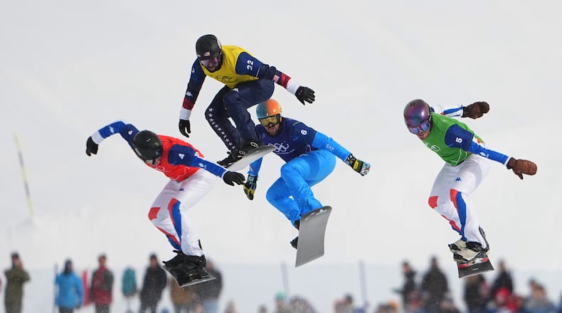 United States' Nick Baumgartner (22), France's Jonas Chollet (4), France's Loan Bozzolo (5), Italy's Lorenzo Sommariva (6) compete during the men's snowboard cross finals at the 2026 Winter Olympics, in Livigno, Italy, Thursday, Feb. 12, 2026. (AP Photo/Lindsey Wasson)