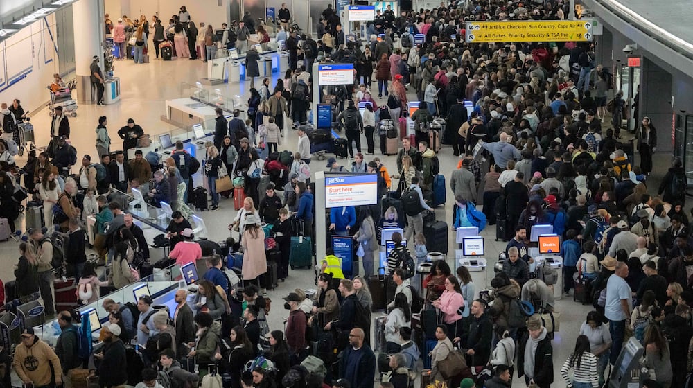 People wait in a TSA line at the John F. Kennedy International Airport, Sunday, March 22, 2026, in New York. (AP Photo/Yuki Iwamura)