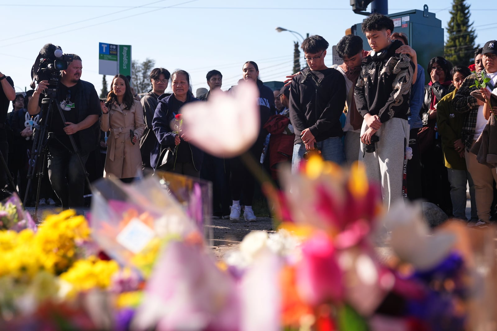 People visit a memorial after a vehicle drove into a crowd during a Filipino heritage festival in Vancouver, British Columbia, Sunday, April 27, 2025. (AP Photo/Lindsey Wasson)