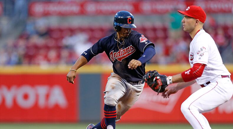 CINCINNATI, OH - MAY 19: Francisco Lindor #12 of the Cleveland Indians safely beats the throw back to Joey Votto #19 of the Cincinnati Reds at first base during the fifth inning at Great American Ball Park on May 19, 2016 in Cincinnati, Ohio. Cleveland defeated Cincinnati 7-2. (Photo by Kirk Irwin/Getty Images)