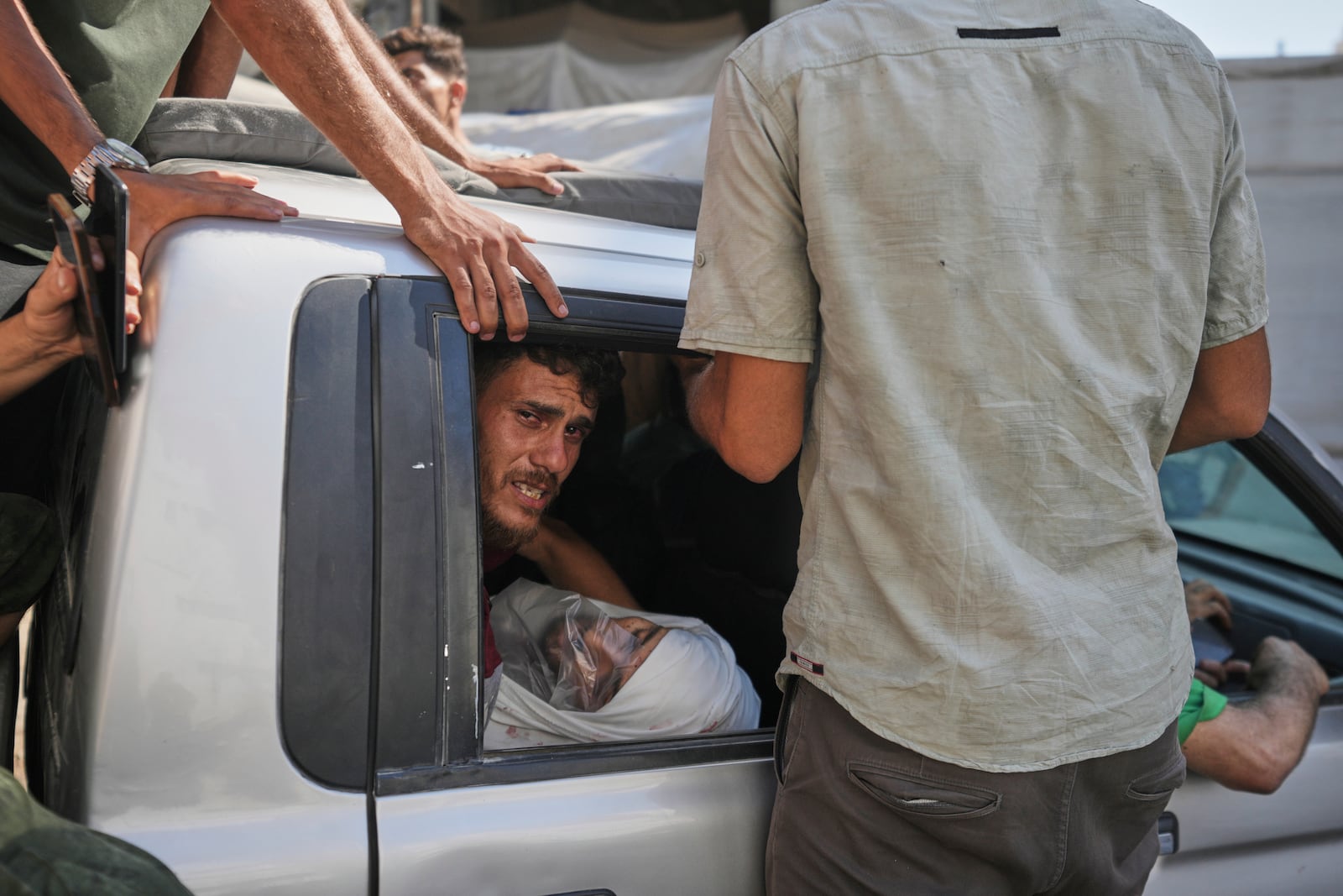 Palestinians carry the body of a relative of Dr. Marwan Sultan, director of the Indonesian Hospital in northern Gaza, who was killed along with him in an Israeli airstrike, at Shifa Hospital in Gaza City on Wednesday, July 2, 2025. (AP Photo/Jehad Alshrafi)