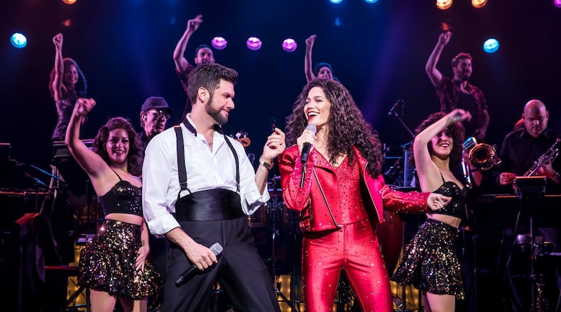 Mauricio Martinez as Emilio Estefan and Christie Prades as Gloria Estefan with the Company in the national tour of “On Your Feet!,” slated March 5-10 at the Schuster Center. CONTRIBUTED/MATTHEW MURPHY