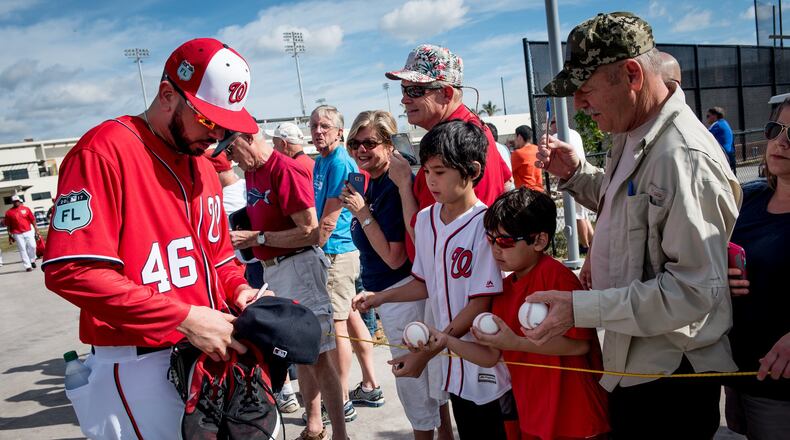 Washington Nationals pitcher Oliver Perez (46) signs hats and baseballs for fans during Spring Training at The Ballpark of the Palm Beaches in West Palm Beach, Fla., on Saturday, Feb. 18, 2017. (Michael Ares / The Palm Beach Post)