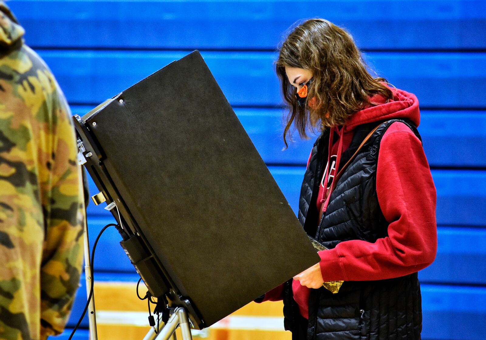 Alexys Napier, 18, votes for the first time on election day Tuesday, Nov. 3, 2020 at Wilson Middle School in Hamilton. NICK GRAHAM / STAFF