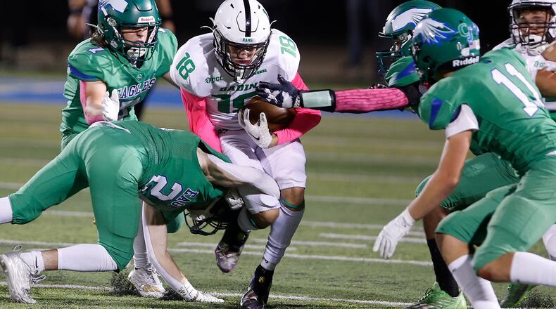 Badin's James Brink is tackled by a pack of CJ defenders. BILL LACKEY/STAFF