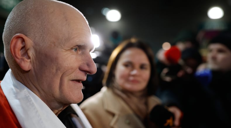 Nobel Peace Prize laureate Ales Bialiatski, one of released Belarusian prisoners, arrives at the U.S. Embassy in Vilnius, Lithuania, on Saturday, Dec. 13, 2025, as Belarusian opposition leader Sviatlana Tsikhanouskaya, background stands near. (AP Photo/Mindaugas Kulbis)