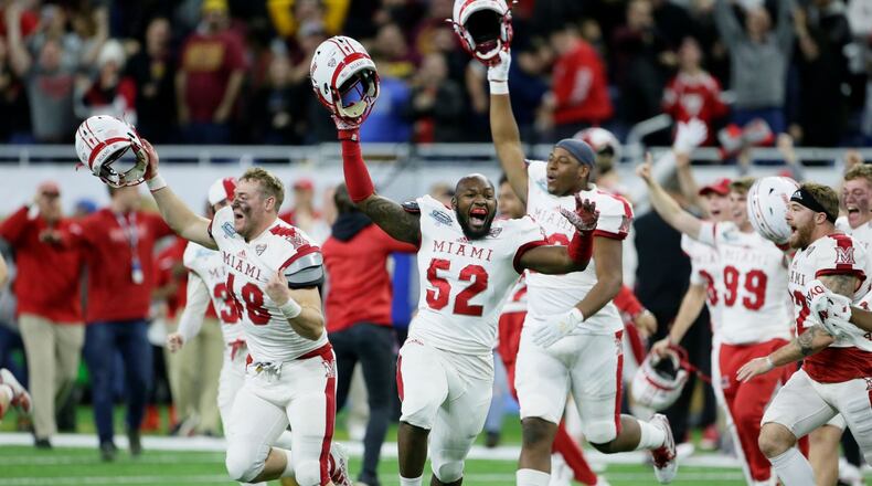 DETROIT, MI - DECEMBER 7: Defensive lineman Ryan Newton #48 of the Miami Redhawks celebrates along with defensive linemen Cam Turner #52 and Kobe Hilton #96 after a 26-21 win over the Central Michigan Chippewas to take the MAC Championship at Ford Field on December 7, 2019, in Detroit, Michigan. (Photo by Duane Burleson/Getty Images)