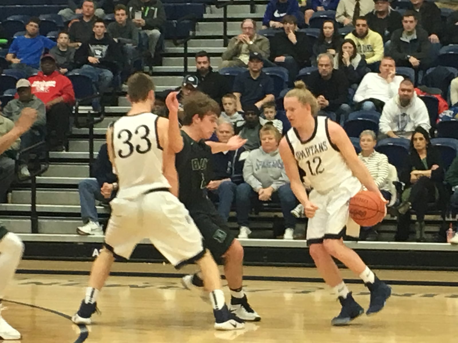 Valley View’s Austin Clark (12) gets some help from teammate Levi McMonigle (33) against Badin’s Evan Grawe on Tuesday night during a Division II sectional semifinal at Fairmont’s Trent Arena. RICK CASSANO/STAFF