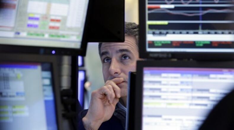 Specialist Anthony Rinaldi works at his post on the floor of the New York Stock Exchange, Tuesday, Materials and financial companies led U.S. stock indexes higher in afternoon trading Tuesday as investors sized up the latest round of company earnings news. Energy stocks also rose as crude oil prices headed higher. (AP Photo/Richard Drew)