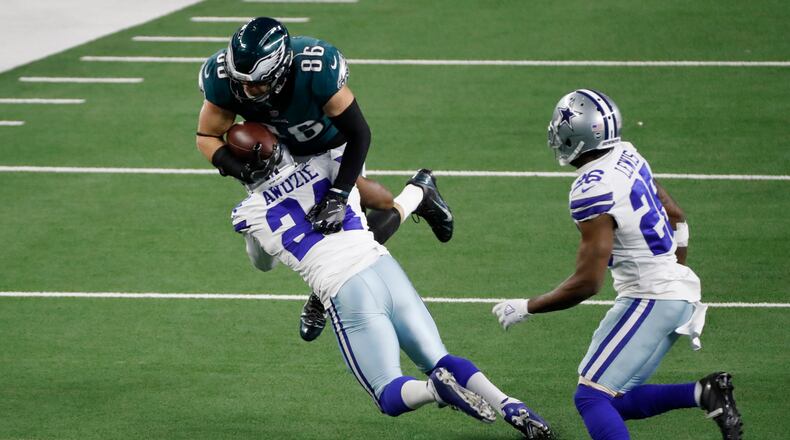 Dallas Cowboys cornerback Chidobe Awuzie (24) stops Philadelphia Eagles tight end Zach Ertz (86) from gaining extra yardage after a catch as cornerback Jourdan Lewis (26) looks on in the second half of an NFL football game in Arlington, Texas, Sunday, Dec. 27. 2020. (AP Photo/Roger Steinman)