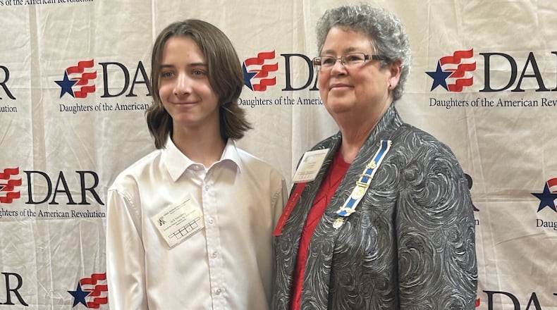 Monroe Schools’ 7th grader Jack Nerenberg’s essay just won national first place in the Daughters of the American Revolution (DAR) contest. Nerenberg received $2,500 from the organization and will travel to Washington, D.C. to the group’s national convention this summer to read a portion of his award-winning essay. He is pictured receiving his initial state award in Columbus with DAR representative Nancy Hutton. CONTRIBUTED