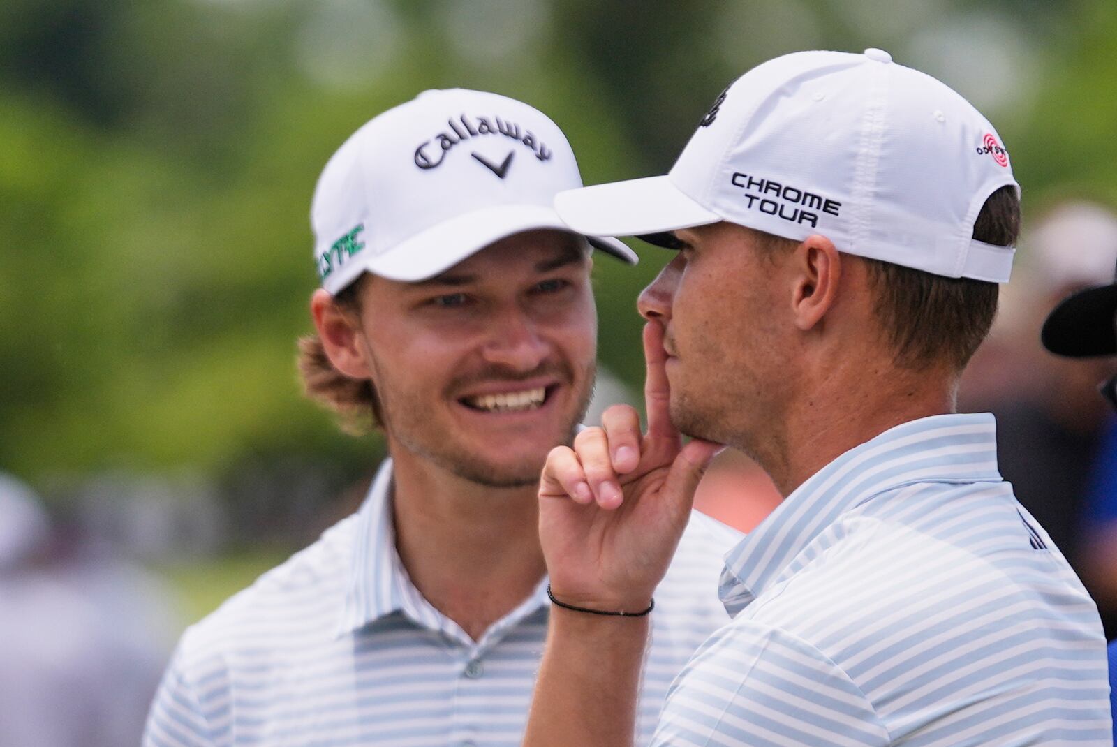 Rasmus Hojgaard, of Denmark, talks with his twin brother and teammate Nicolai Hojgaard, of Denmark, on the 2nd hole during the final round of the PGA Zurich Classic golf tournament at TPC Louisiana in Avondale, La., Sunday, April 27, 2025. (AP Photo/Gerald Herbert)