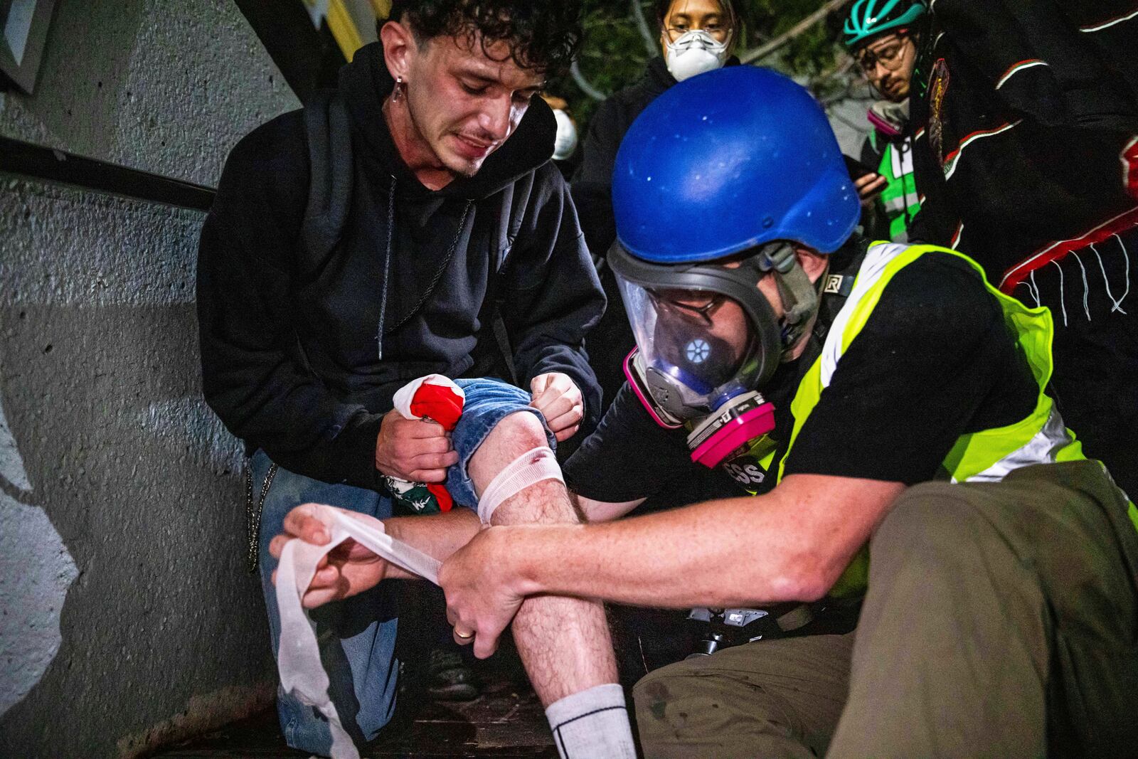 An injured person is tended to during protests over the Trump administration's immigration raids in Los Angeles, Monday, June 9, 2025. (AP Photo/Ethan Swope)