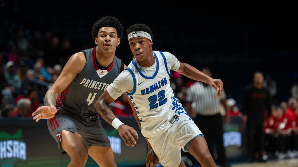 Hamilton’s Elijah Jones is defended by Princeton’s Kam Mercer during their Division I district final game Saturday at Cintas Center. AJ FULLAM / CONTRIBUTED