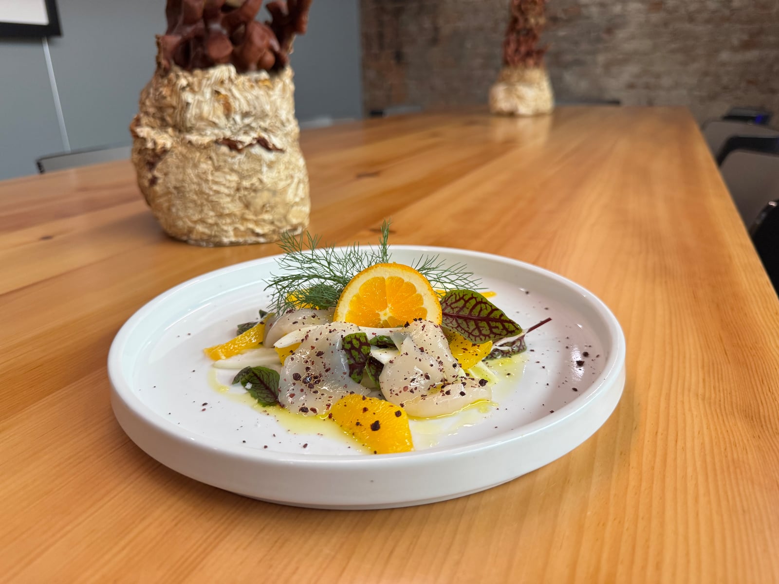 Delicate Hokkaido scallop crudo at Carmagnola in Hamilton is served with shaved fennel, orange supremes, sorrel and fennel fronds, finished with Urfa chili, flaked sea salt and extra virgin olive oil. NINA WEIERMAN/CONTRIBUTED