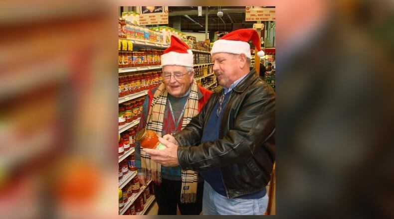 Fairfield Rotary members John Brunner, left, and Jeff Holtegel shopped at Jungle Jim’s to buy food for families the service organization supported in a past annual Christmas Project shopping day. The Rotary provides a Christmas dinner and presents for Fairfield area families in need. The project is funded through the Rotary’s annual Spring Charity Auction, which is on April 17 in 2020. FILE/PROVIDED
