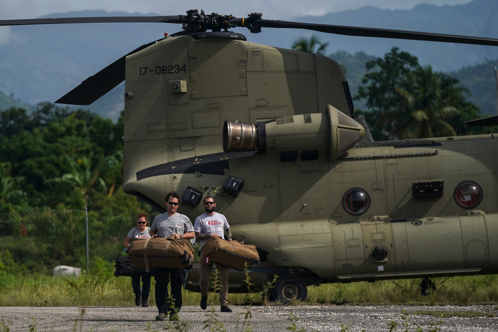 FILE - Team Rubicon's disaster response members unload aid at the airport following a 7.2 magnitude earthquake, in Les Cayes, Haiti, Aug. 19, 2021. (AP Photo/Fernando Llano, File)