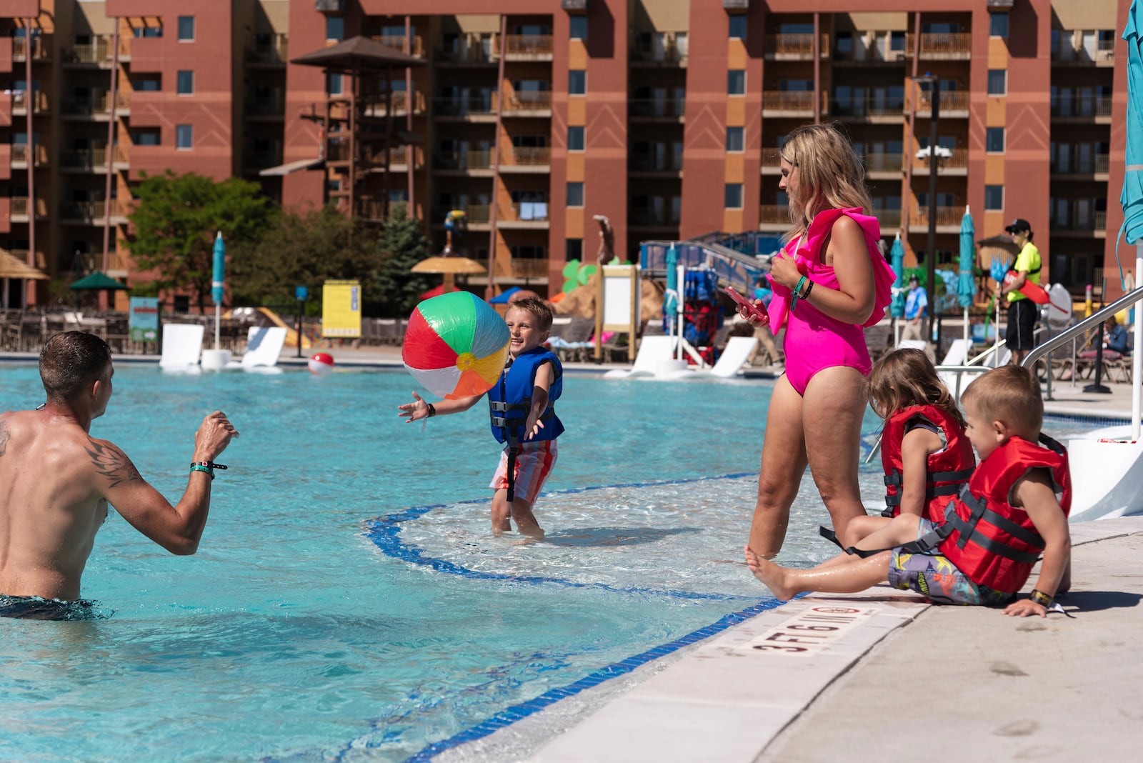 IMAGE DISTRIBUTED FOR KALAHARI RESORTS - A family enjoys the new 15,000 sq. ft. outdoor pool at Kalahari Resort in Sandusky, Ohio. The pool holds 365,000 gallons of water and is the largest in any of the resort's four properties nationwide. Friday, May 26, 2023. (Kaitlin K Walsh/AP Images for Kalahari Resorts)