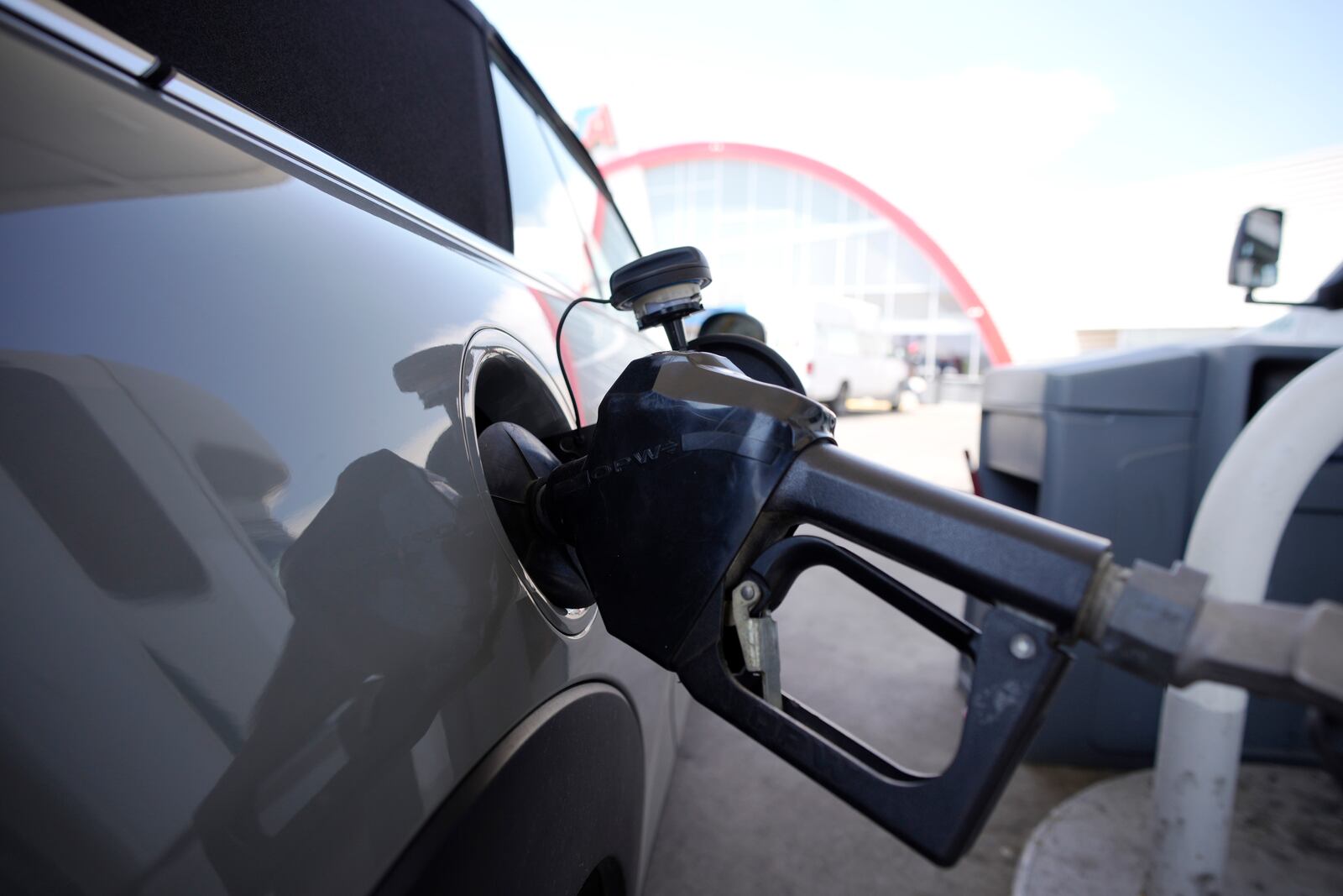 FILE - A motorist fills up their car at a Shell gas station ahead of Memorial Day, Friday, May 26, 2023, in Commerce City, Colo. (AP Photo/David Zalubowski, File)
