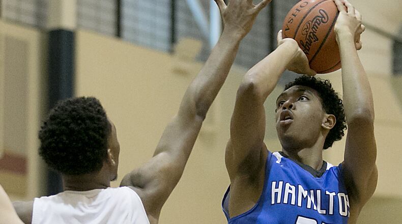 Hamilton center Cameron Benson puts up a shot over Monroe forward Tristan Backas during the All-Butler County All-Star boys basketball game at the Hamilton Athletic Center on Saturday night. CONTRIBUTED PHOTO BY E.L. HUBBARD