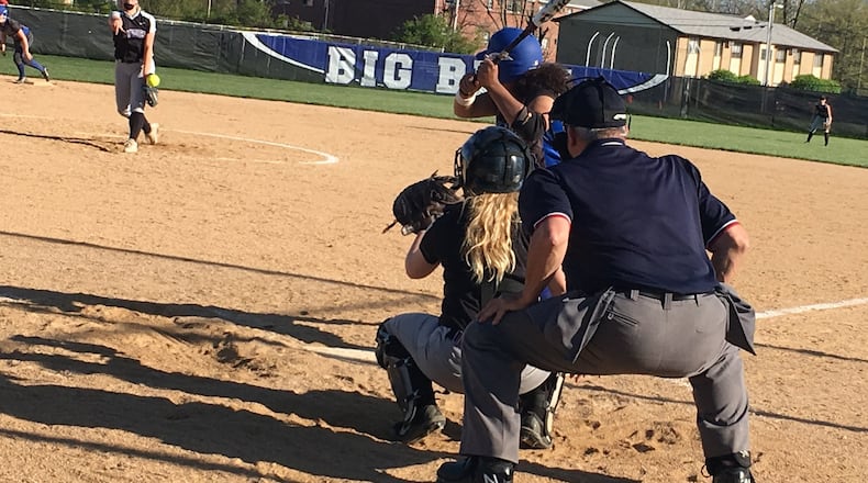 Middletown’s Carly Metcalf sends a pitch toward her catcher, Katie Pearson, and Hamilton’s Mya Halcomb (23) during an April 30, 2018, game at HHS. RICK CASSANO/STAFF