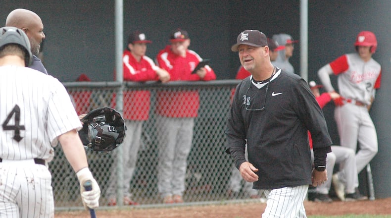 Lakota East coach Ray Hamilton talks with the home-plate umpire Saturday during the Thunderhawks’ 5-3, nine-inning loss to visiting Lakota West in Greater Miami Conference baseball action. RICK CASSANO/STAFF