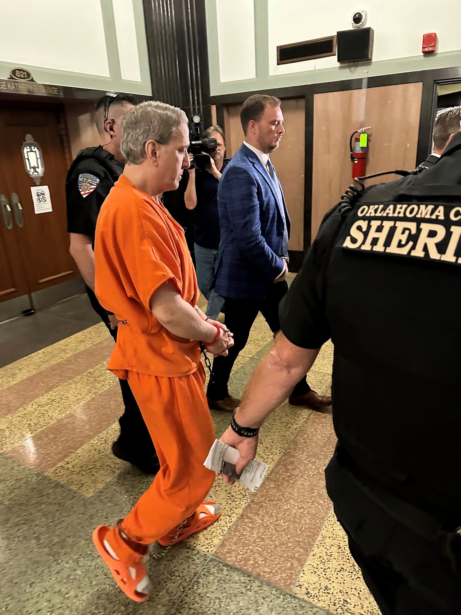 Oklahoma County Sheriff's deputies lead longtime death row inmate Richard Glossip to a courtroom on Monday, June 9, 2025, at the Oklahoma County Courthouse in Oklahoma City. (AP Photo/Sean Murphy)