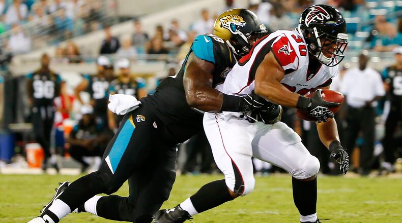 JACKSONVILLE, FL - AUGUST 28: Josh Vaugh #30 of the Atlanta Falcons runs against Chris Smith #98 of the Jacksonville Jaguars during the preseason NFL game at EverBank Field on August 28, 2014 in Jacksonville, Florida. (Photo by Sam Greenwood/Getty Images)