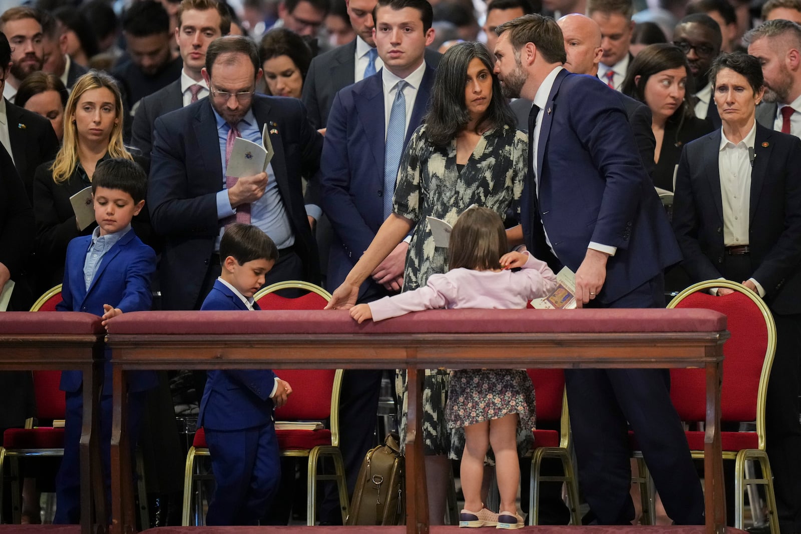 U.S. Vice President JD Vance, and his wife Usha Vance, with their daughter Mirabel, back to camera, and sons Vivek and Ewan, left, attend a Good Friday service inside St. Peter's Basilica at the Vatican, Friday, April 18, 2025. (AP Photo/Alessandra Tarantino)