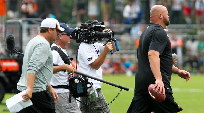 Members of the HBO series Hard Knocks, follow injured offensive tackle Andrew Whitworth during Bengals practice, Wednesday, July 31, 2013. GREG LYNCH / STAFF