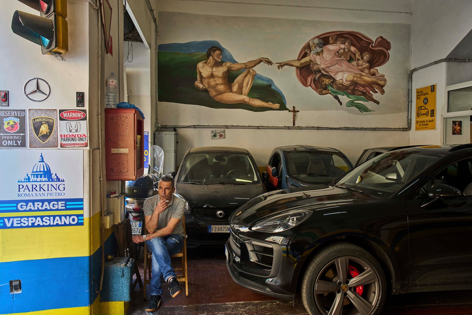 A reproduction of Michelangelo's "The Creation of Adam" is painted on a parking in Rome, Tuesday, May 6, 2025. (AP Photo/Bernat Armangue)