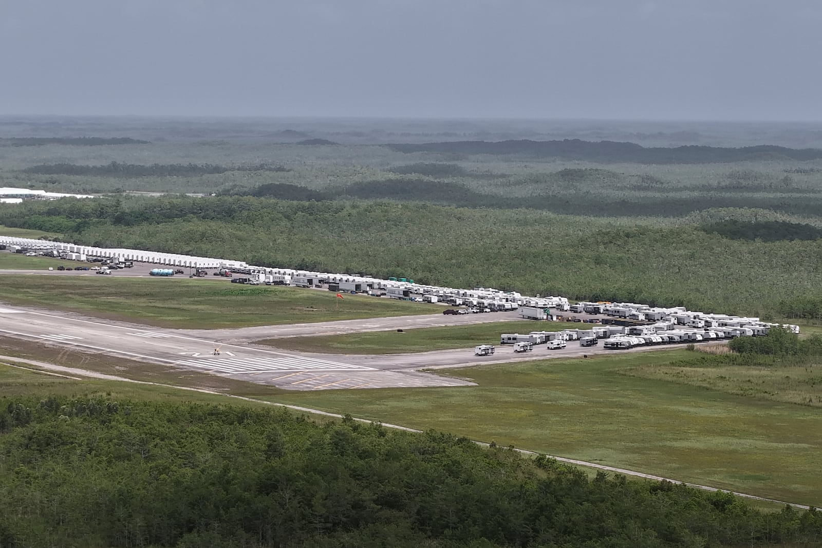 This aerial photo shows that the state is plowing ahead with building a an immigration detention facility with heavy-duty tents, trailers and other temporary buildings at the Miami Dade County-owned airfield in the Big Cypress National Preserve, about 45 miles (72 kilometers) west of downtown Miami, This Friday, June 27, 2025. (AP Photo/Daniel Kozin)