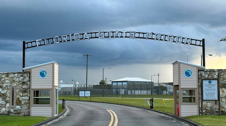 FILE - Clouds hover over the entrance of the Florida State Prison in Starke, Fla., Aug. 3, 2023. (AP Photo/Curt Anderson, file)