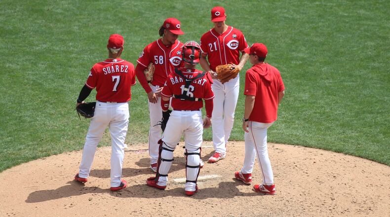 Reds manager David Bell visits the mound during a game against the Pirates on July 31, 2019, at Great American Ball Park in Cincinnati. David Jablonski/Staff