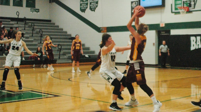 Veronica Allen (31) of Ross is surrounded by Badin’s Emma Adams (12) and Shelby Nusbaum (right) during Wednesday night’s game at Mulcahey Gym in Hamilton. Badin won 59-26. RICK CASSANO/STAFF