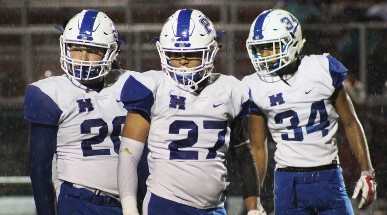 Hamilton’s Elijah Spradling (20), Jordan Jones (27) and Maleek Kaiser (34) look for a signal during Friday night’s 21-20 loss to Princeton in Sharonville. CONTRIBUTED PHOTO BY ISAIAH MILLER