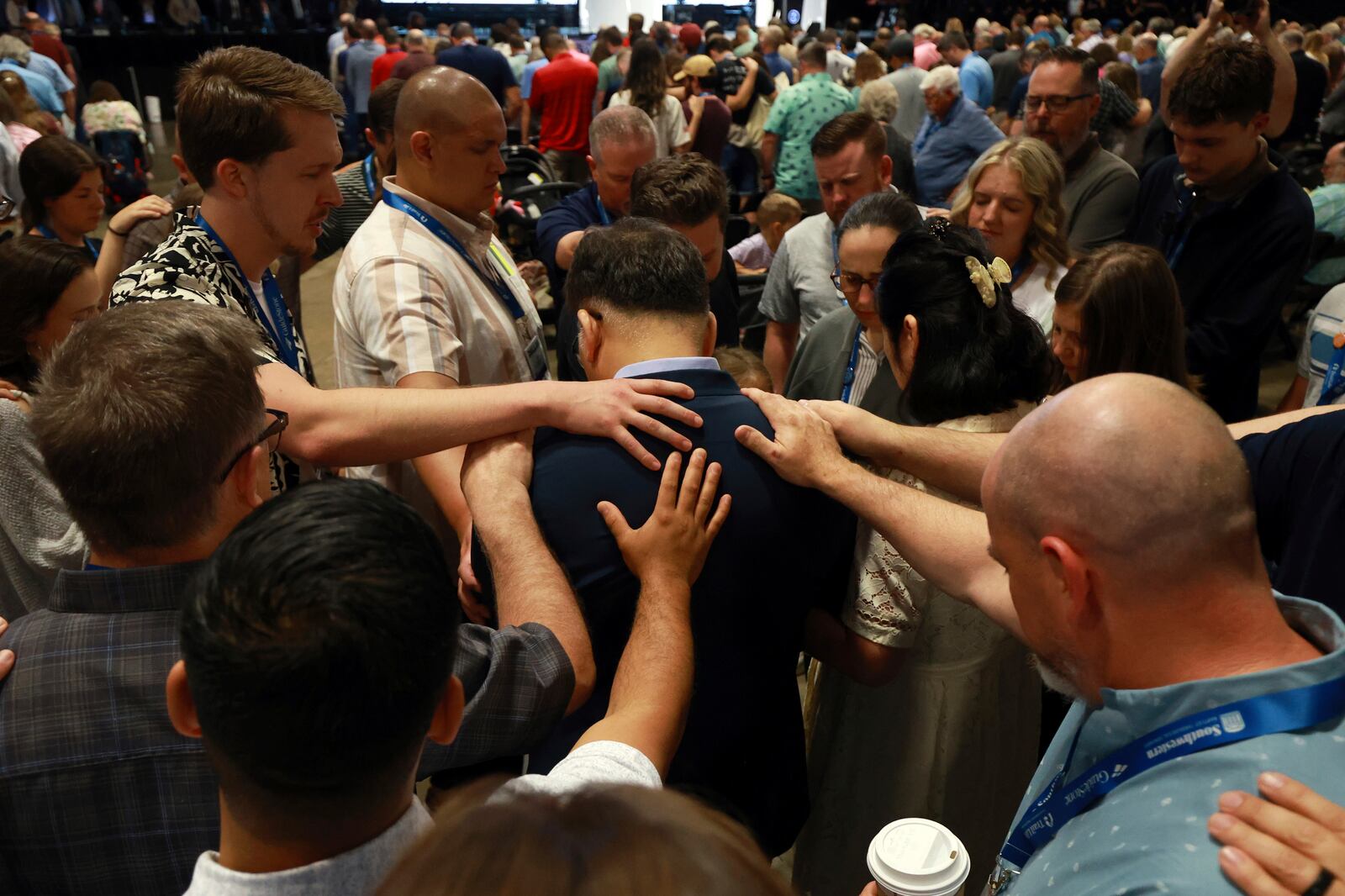 Messengers attending the Southern Baptist Convention lay on hands and pray over missionaries during the 2025 SBC Annual Meeting, Tuesday, June 10, 2025, in Dallas. (AP Photo/Richard W. Rodriguez)