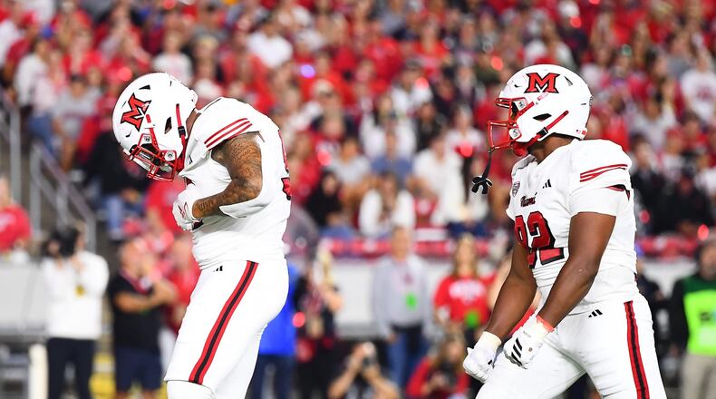 Miami's Nasir Washington (left) celebrates a sack against Wisconsin. KYLE HENDRIX / CONTRIBUTED