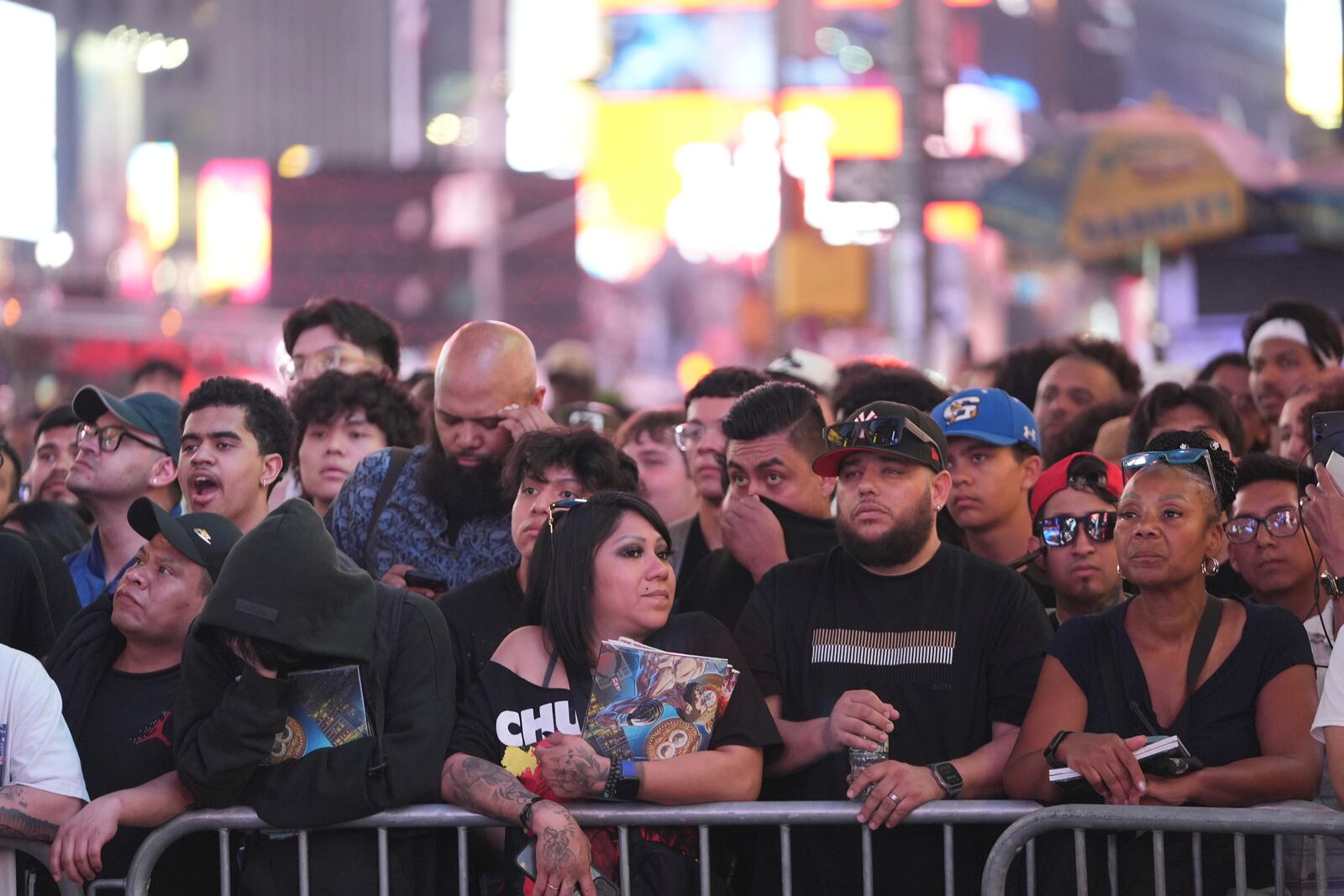 People gather in Times Square to watch a boxing match Friday, May 2, 2025, in New York. (AP Photo/Frank Franklin II)