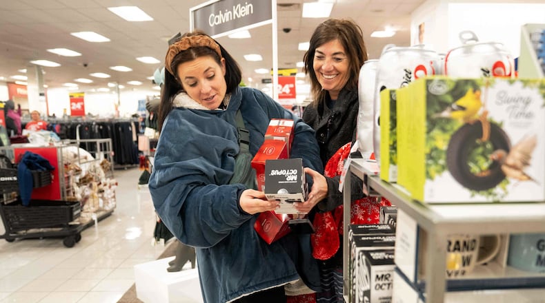 Becca Mendoza and Tammi Hines look at products as shoppers browse through Kohl's department store for Black Friday deals, Friday, Nov. 28, 2025, in Woodstock, Ga. (AP Photo/Megan Varner)