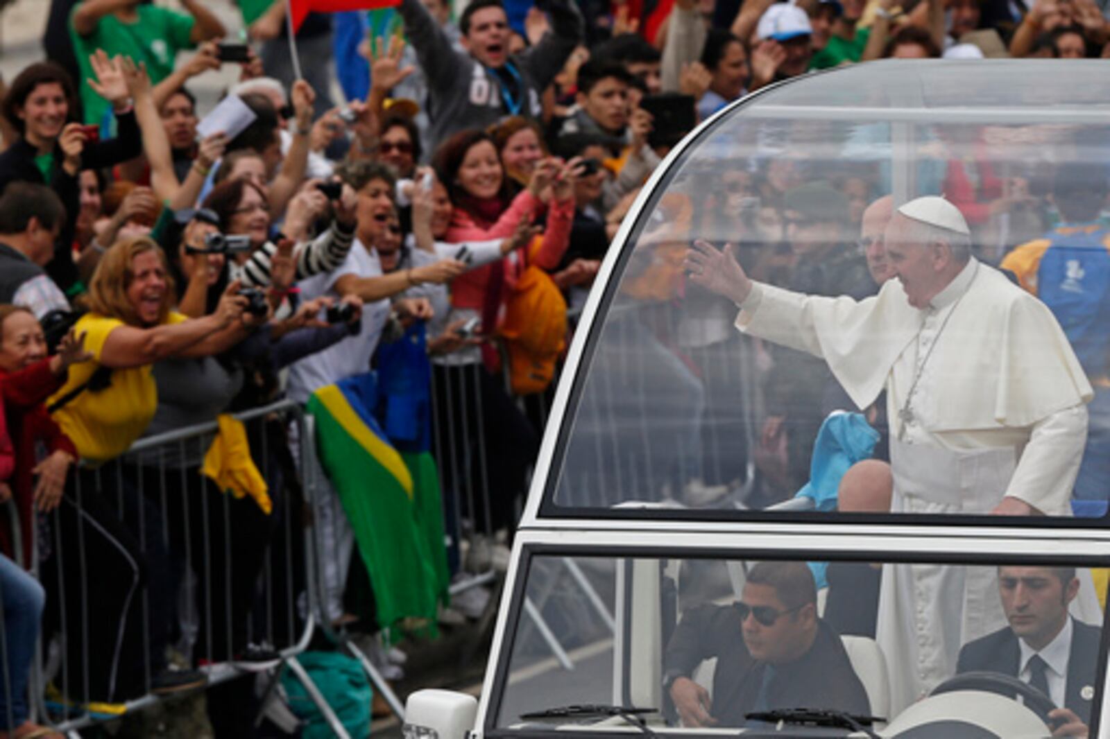 FILE - Pope Francis waves from the popemobile as he rides along the Copacabana beachfront on his way to celebrate mass for World Youth Day, in Rio de Janeiro, Brazil, Sunday, July 28, 2013. (AP Photo/Silvia Izquierdo, File)