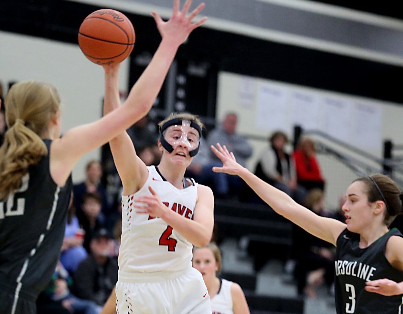 Talawanda guard Emma Wright passes the ball as Ursuline’s Maddie Stuhlreyer (22) and Elle Folan (3) pressure during their Division I sectional game at Lakota East on Feb. 15. CONTRIBUTED PHOTO BY E.L. HUBBARD