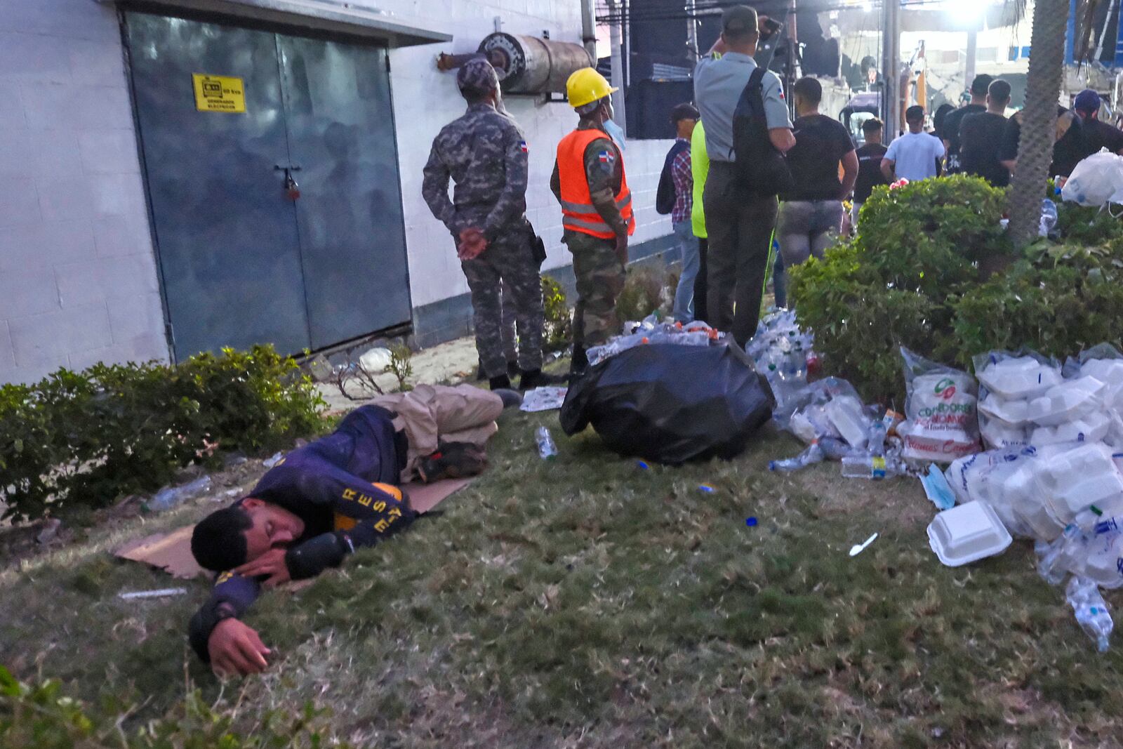A rescue worker rests as others continue the search for survivors at the Jet Set nightclub after its roof collapsed two nights prior during a merengue concert in Santo Domingo, Dominican Republic, Wednesday, April 9, 2025. (AP Photo/Ricardo Hernandez)