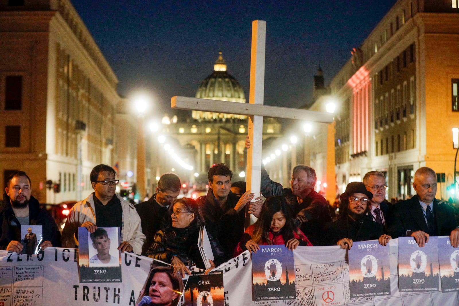 FILE - Survivors of sex abuse hold a cross as they gather in front of St. Peter's Square at the Vatican during a vigil prayer for victims of sexual abuse, in Rome, Feb. 21, 2019. (AP Photo/Gregorio Borgia, File)