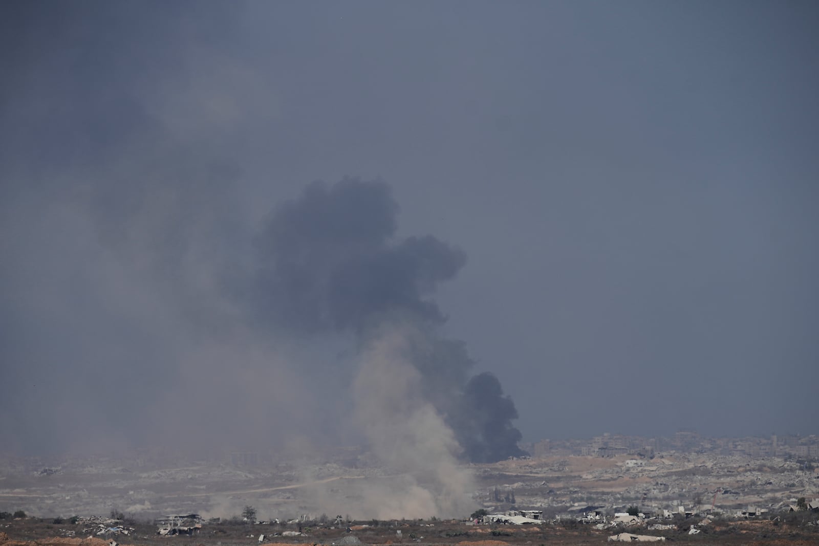 Smoke from an Israeli bombardment rises over the Gaza Strip, seen from southern Israel, Sunday, July 6, 2025. (AP Photo/Ohad Zwigenberg)