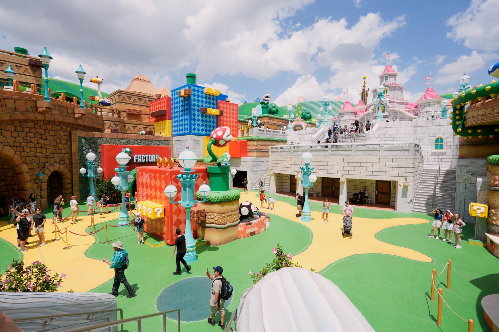 Guests stroll around the various parts of Super Nintendo World at Epic Universe at Universal Resort Orlando Thursday, April 10, 2025, in Orlando, Fla. (AP Photo/John Raoux)