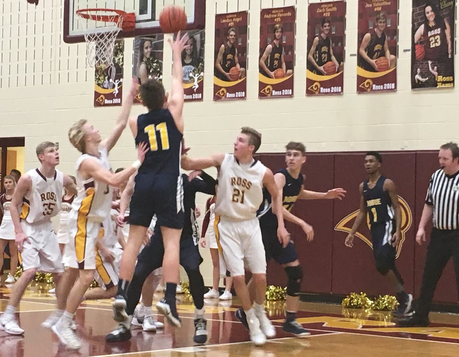 Monroe’s Matt DeHart (11) gets off a shot between Cody Geers (35), Dylan Zimmerman (3) and Landen Angel (21) of host Ross on Tuesday night. RICK CASSANO/STAFF
